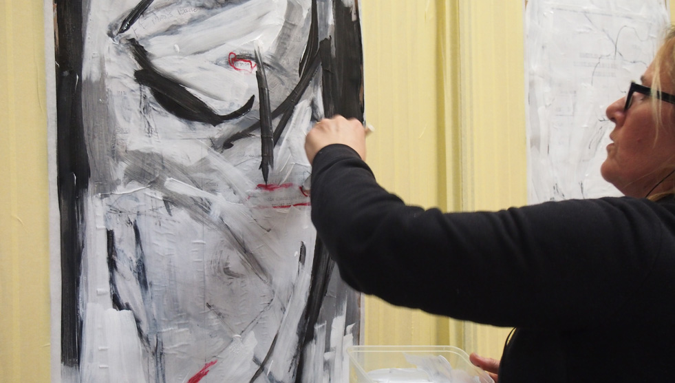 Ugly: A woman is painting an abstract work in shades of black, white and grey