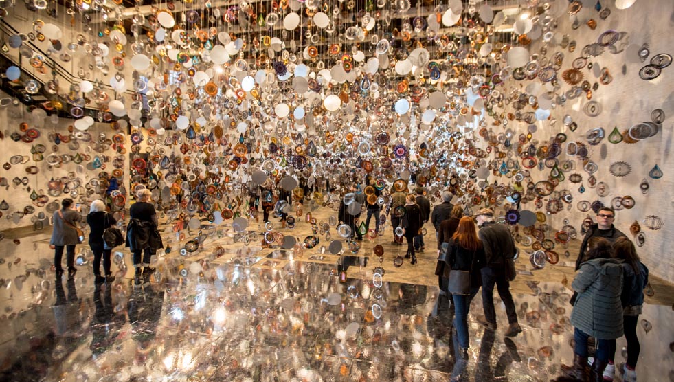 Volunteer: image of an art installation with many dangling objects and reflective pieces