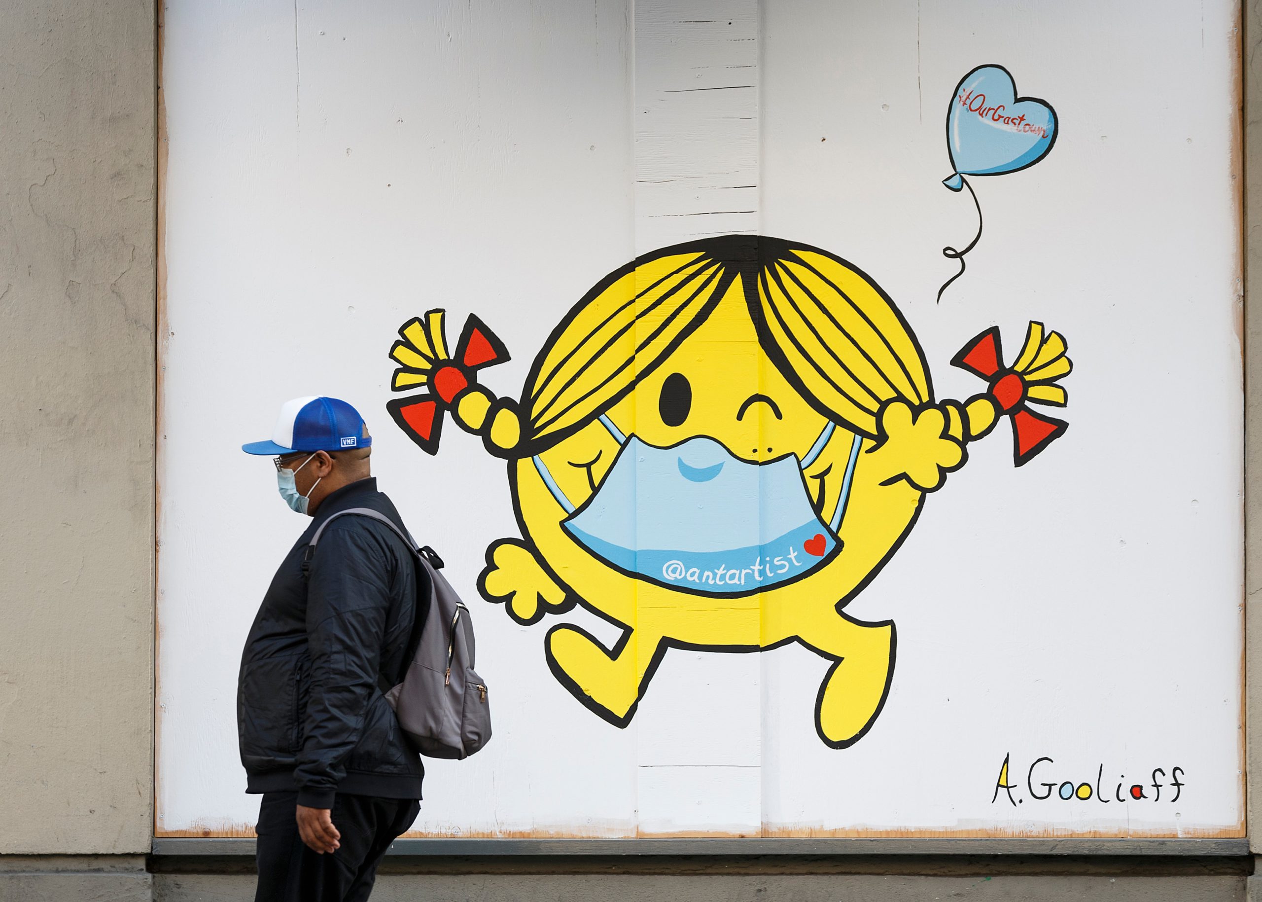 a street mural featuring a Mr Men character wearing a face mask