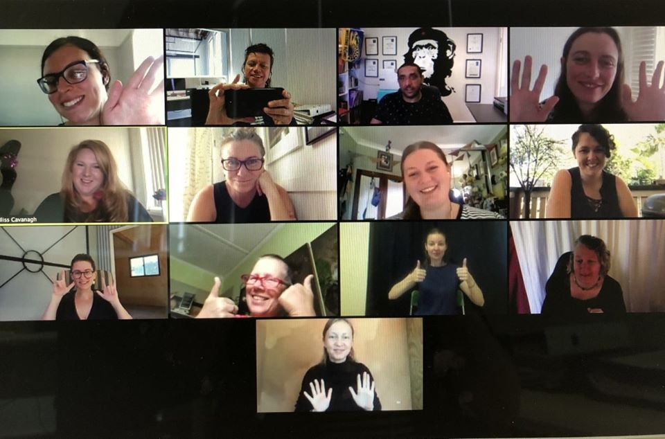 Many different faces in rectangles during a Zoom online training session.