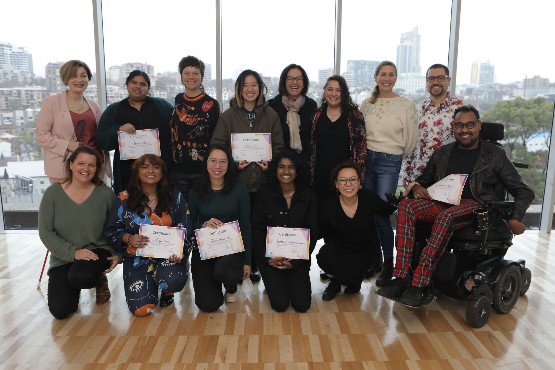 Group photo from the 2022 Disability and Culturally Diverse Internship Graduation Ceremony featuring graduating interns, staff from Accessible Arts and Diversity Arts Australia and ceremony keynote speaker. Photo by Dieter Knierim