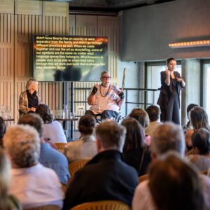 Uncle Paul Calcott addresses audience at Auslan interpreted and captioned event. Photo by Rob Studdert.